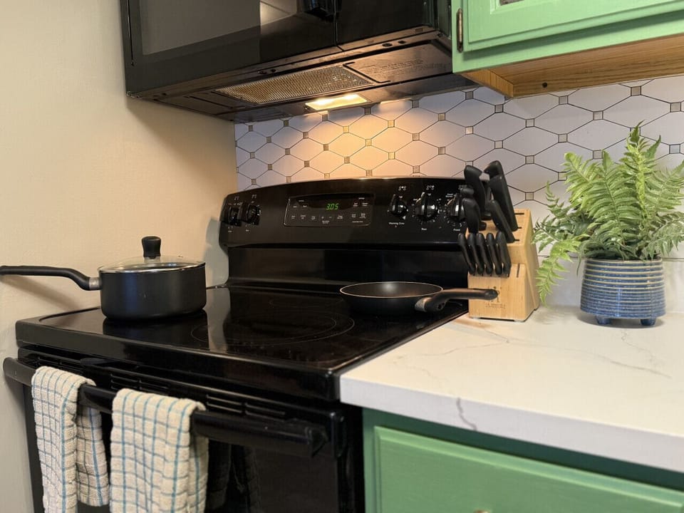 Kitchen equipped with basic cooking essentials.