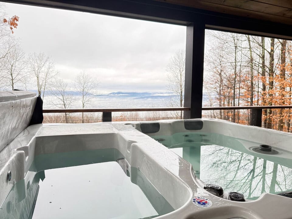 Unwind in the private outdoor hot tub while overlooking the serene forest