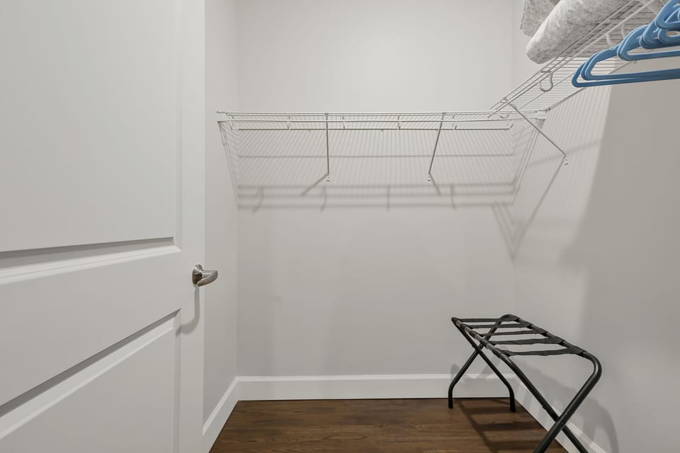 Large walk-in closets with luggage racks, hangers, air mattress, linens /pillows
