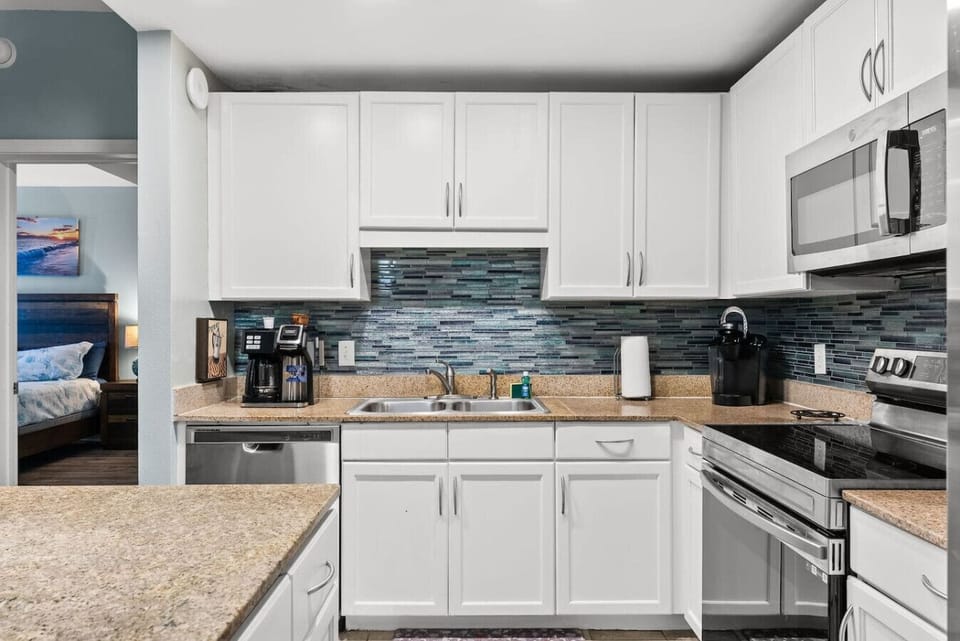 Bright and spacious kitchen with island seating, stainless appliances, and ample storage for extended stays.