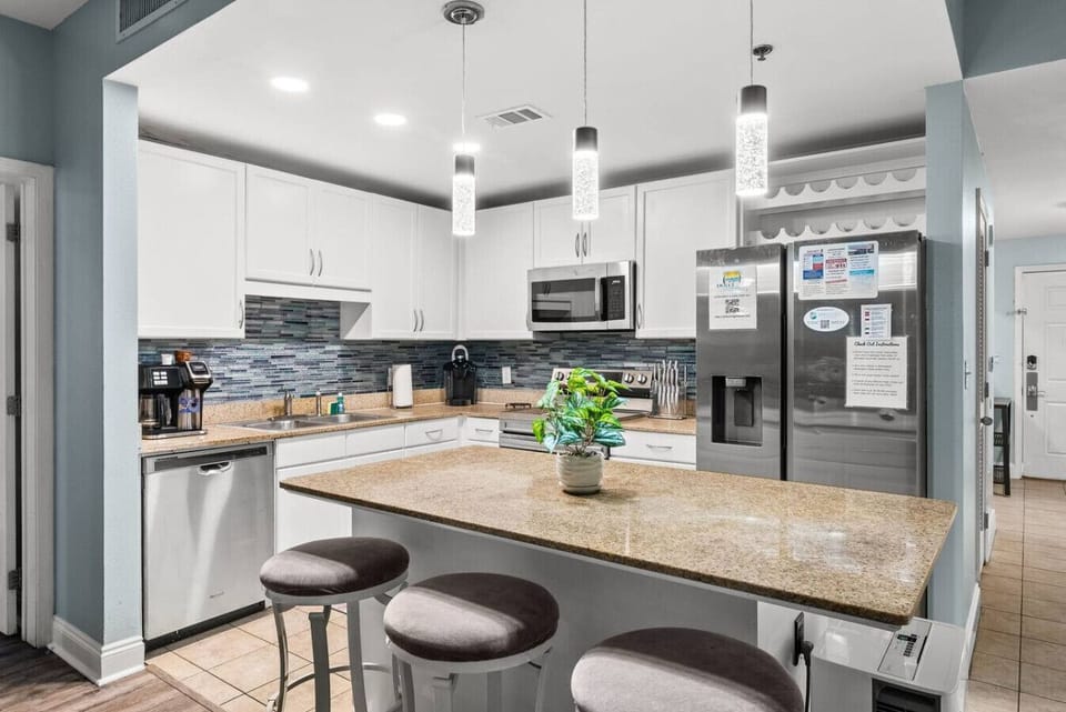 Fully equipped modern kitchen with granite countertops, island seating, and everything you need for meal prep.