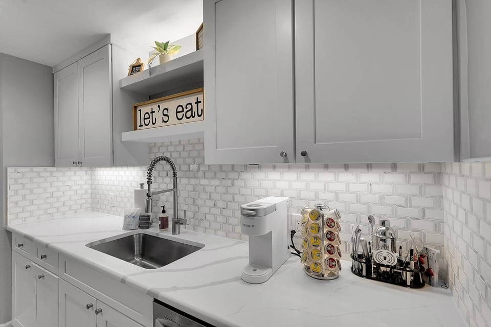 Cookware, dinnerware, many kitchen tools and small appliances are provided, including a Keurig coffee maker.