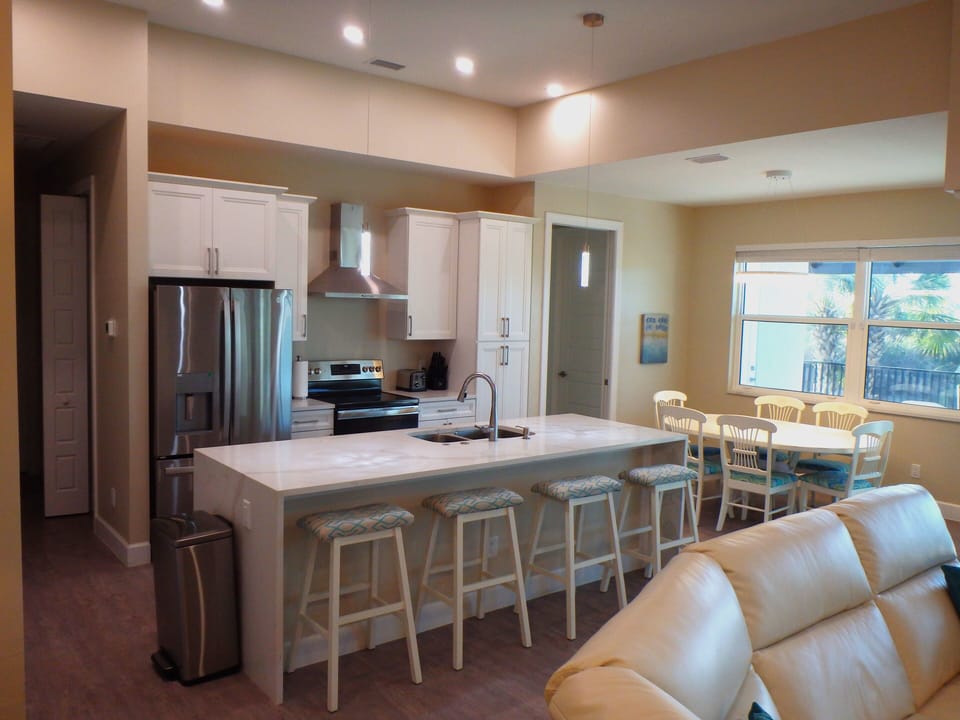 Modern Kitchen & Dining for Six with Pool Views and Natural Light