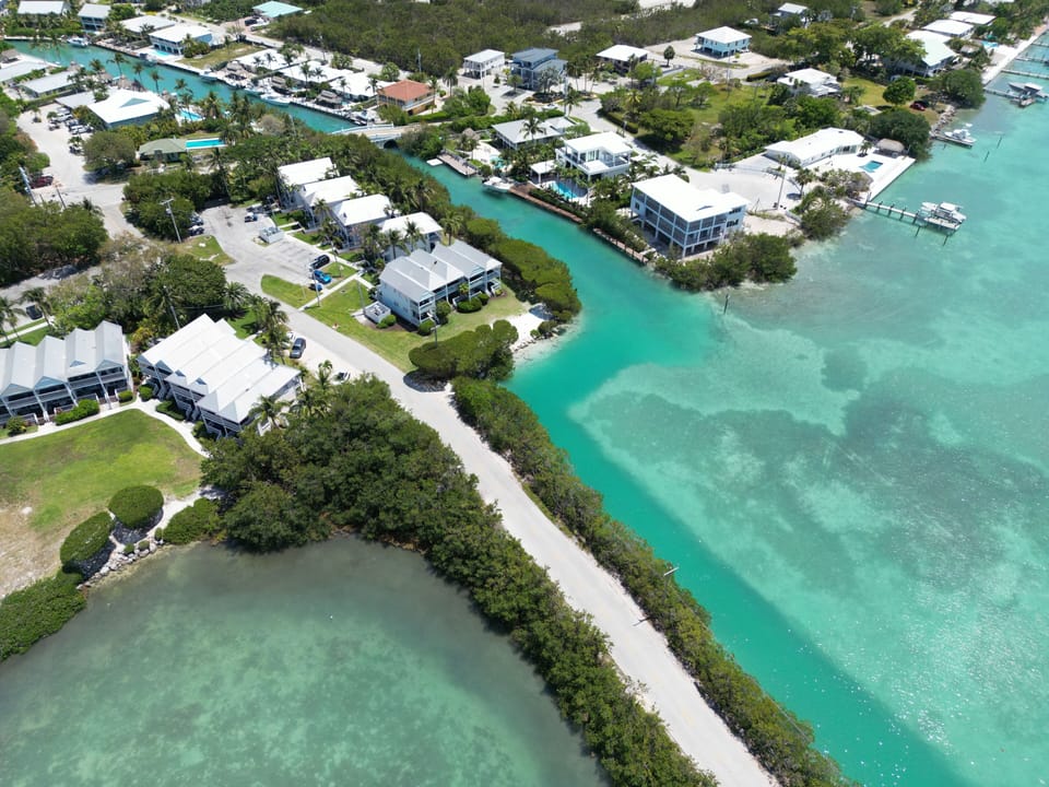 Aerial view of the Villa and its waterfront surroundings.