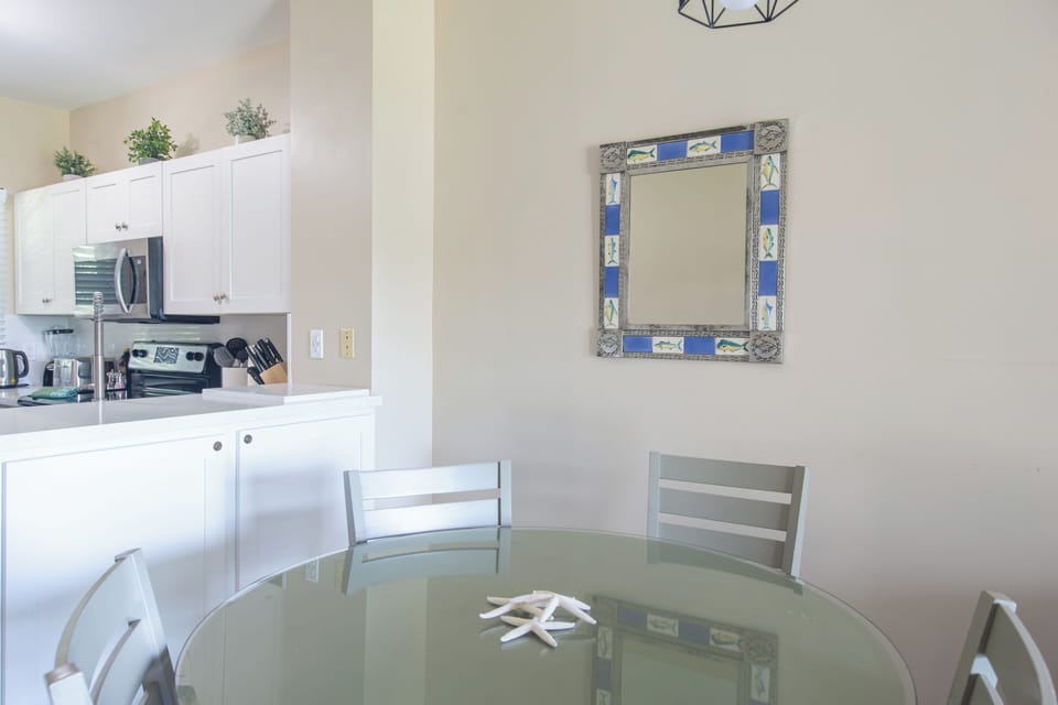 The dining table comfortably seats four guests.
