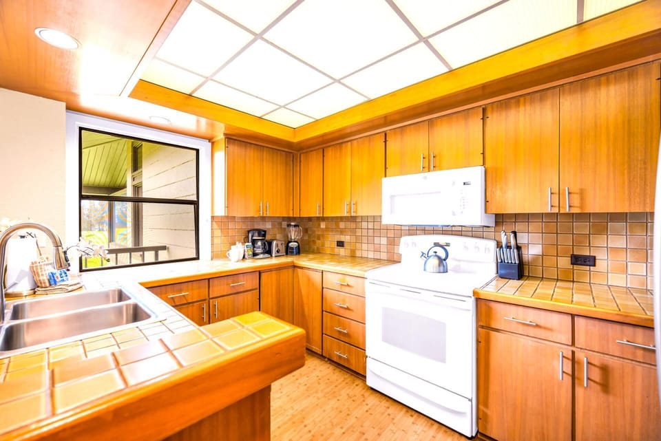 Prepare meals with ease in your open kitchen, fully equipped with granite counters and modern appliances.