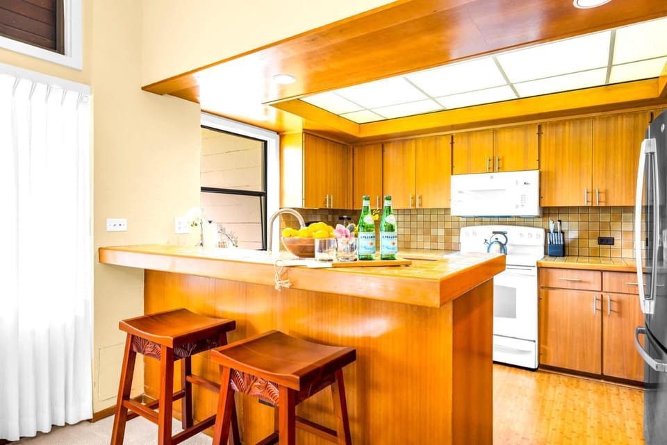 Bar seating bridges the kitchen and living areas for easy breakfasts and quick bites.