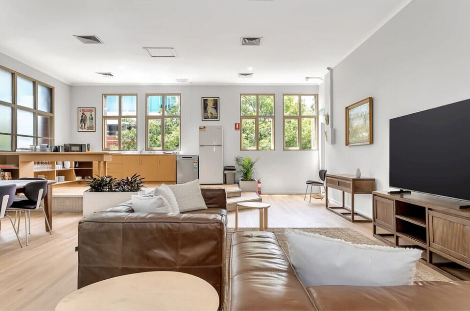 A seamless flow between living and dining, featuring large windows that flood the home with natural light.