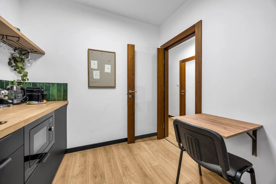 Compact Kitchen with Useful Appliances and Dining Table | Book Now with RENTUJEMY