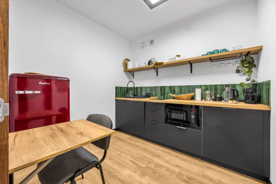Compact Kitchen with Useful Appliances and Dining Table | Book Now with RENTUJEMY