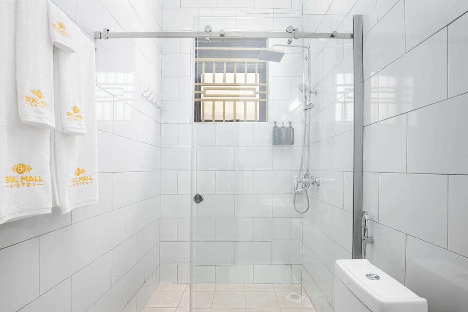 Deluxe Suite, Balcony, City View | Bathroom | Shower, eco-friendly toiletries, hair dryer, slippers