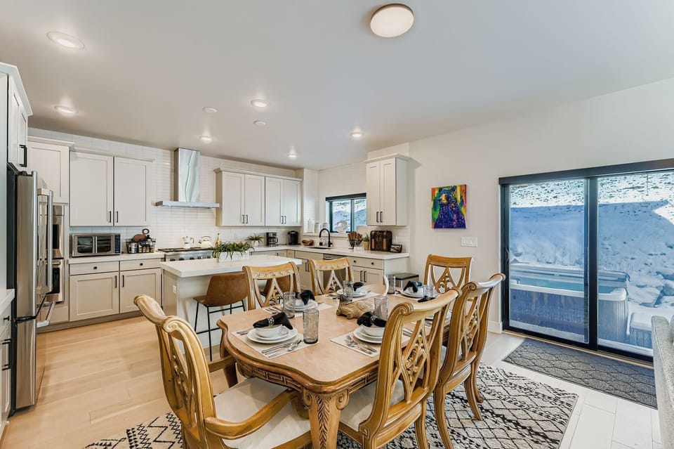Your fully-equipped kitchen and dining area features modern appliances, granite countertops, and a welcoming dining table perfect for sharing meals with stunning desert views.
