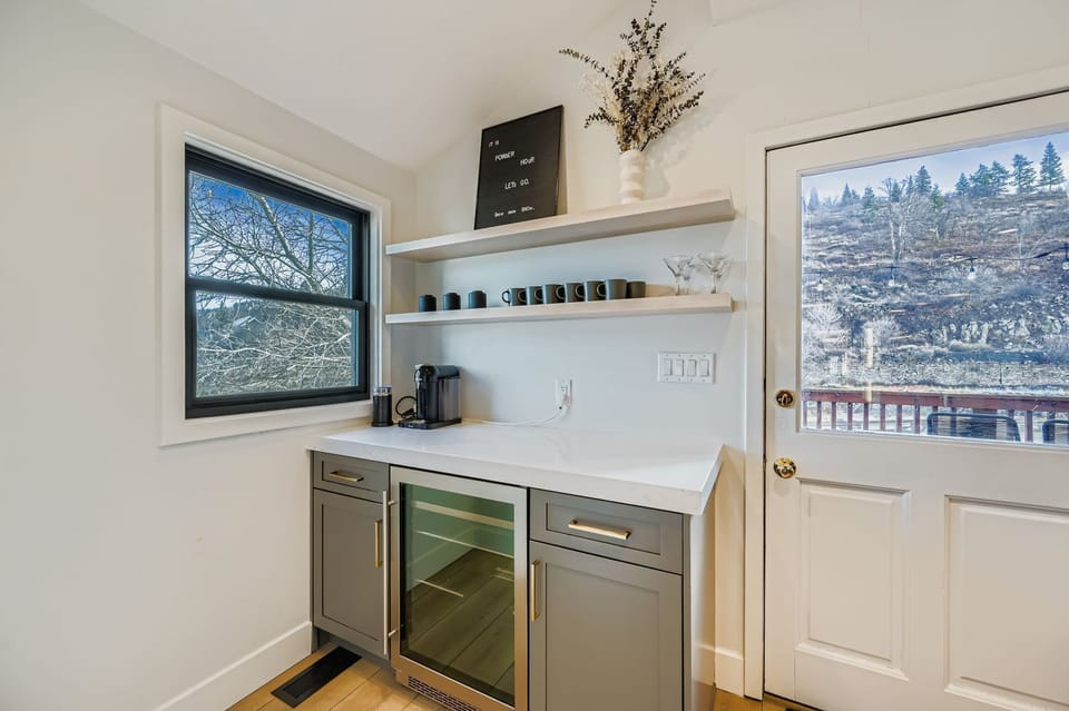 Your morning coffee ritual becomes a joy in this thoughtfully designed kitchenette, where you'll sip your brew while gazing at snow-kissed trees through the window.