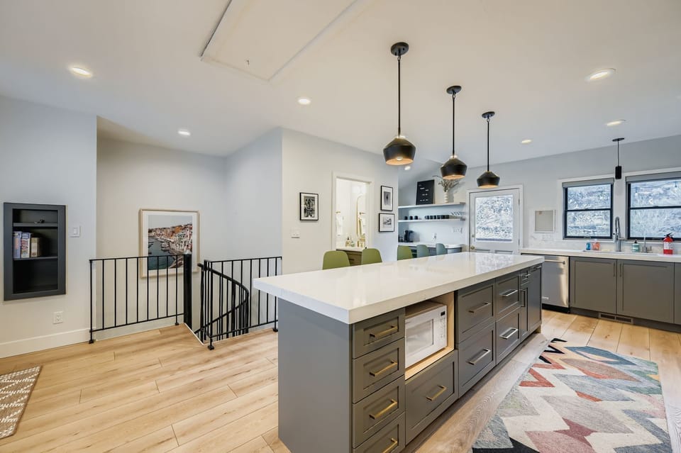 Step into your modern culinary haven where sleek pendant lights dance above a spacious island, perfect for morning coffee or evening wine. .