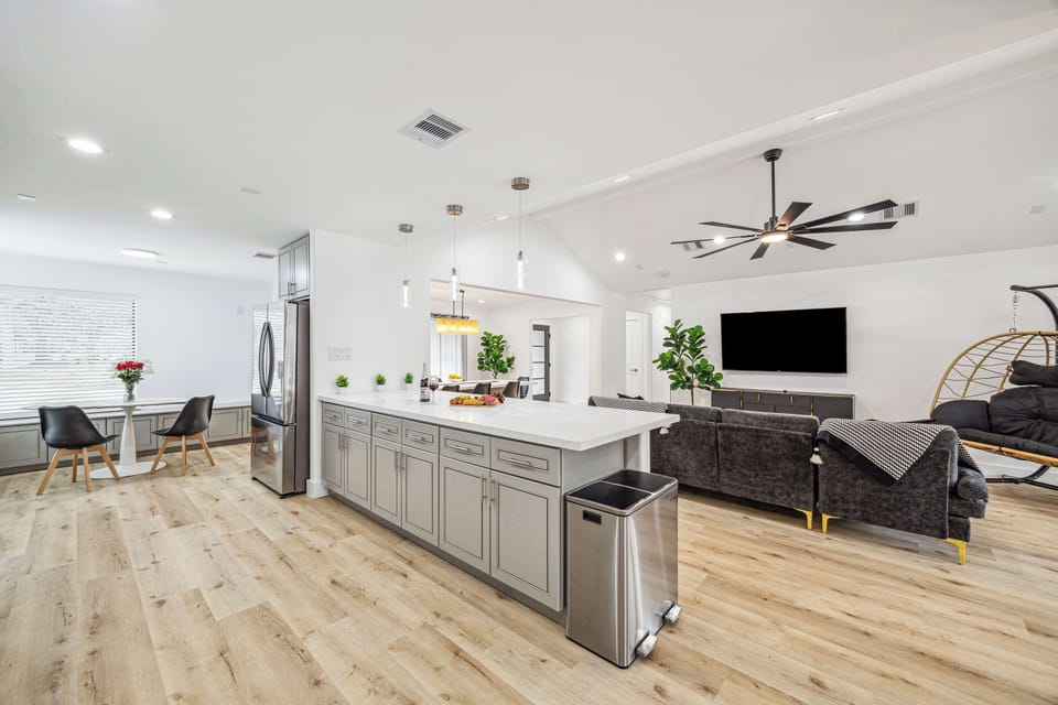 A Modern Open-Concept Space Showcasing A Sleek Countertop, Overlooking The Cozy Living Room