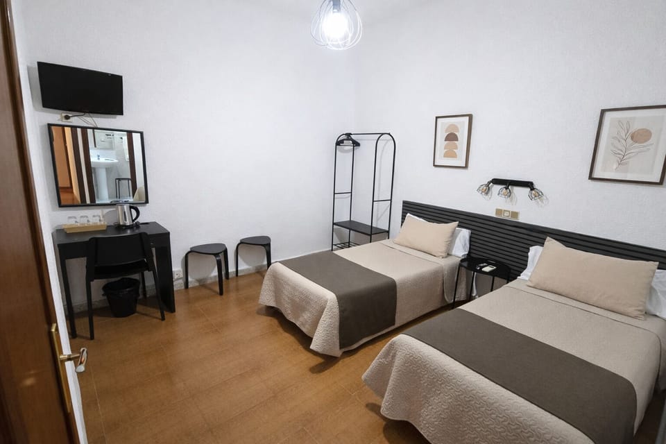 Standard Triple Room, Courtyard View | Minibar, iron/ironing board, bed sheets