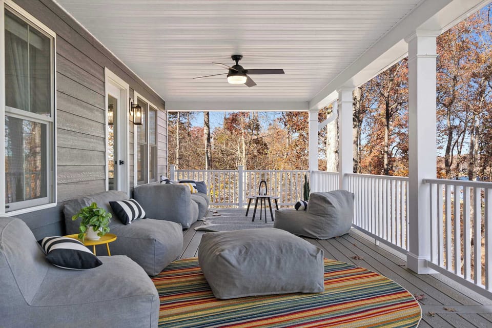 Covered Deck - Plush lounge seating, colorful pillows, and ceiling fans make this wraparound porch a favorite spot to unwind.