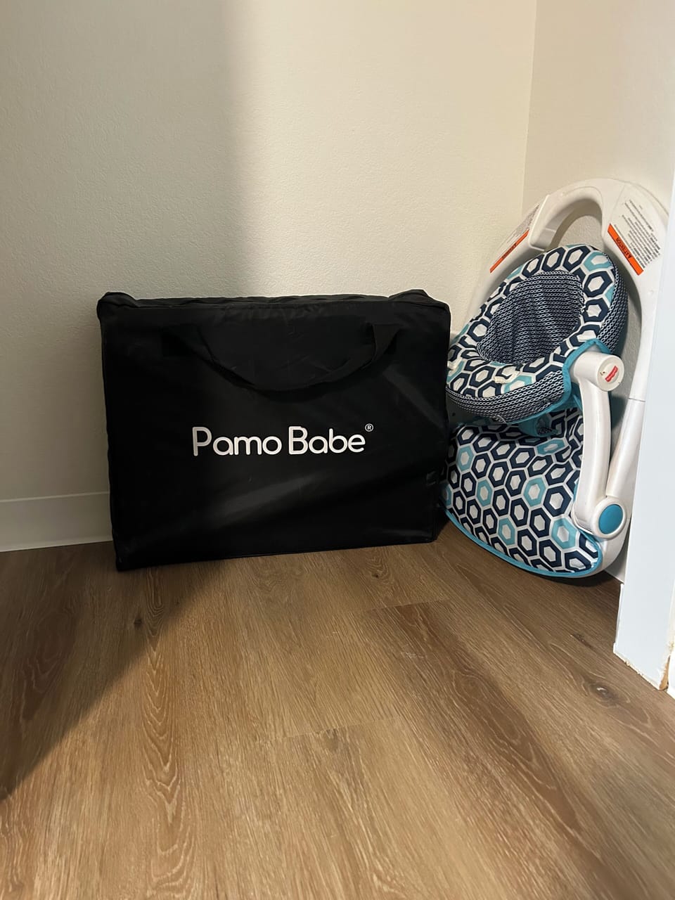 portable baby play pen and floor chair available in the primary bedroom