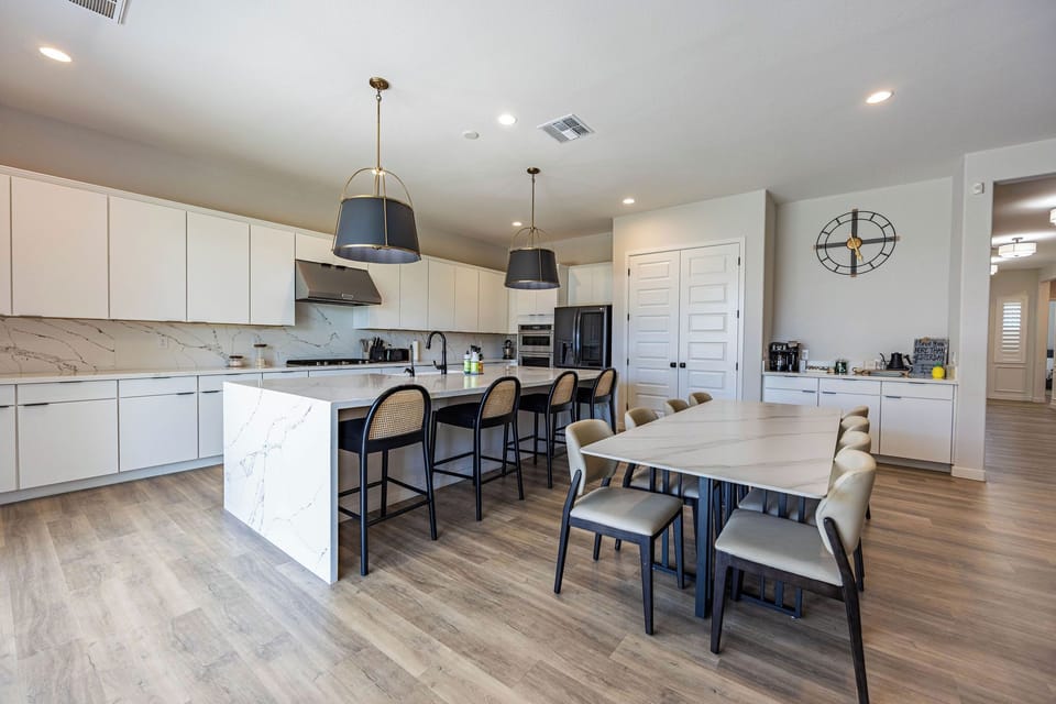 Galley style kitchen with massive island and dining table.
