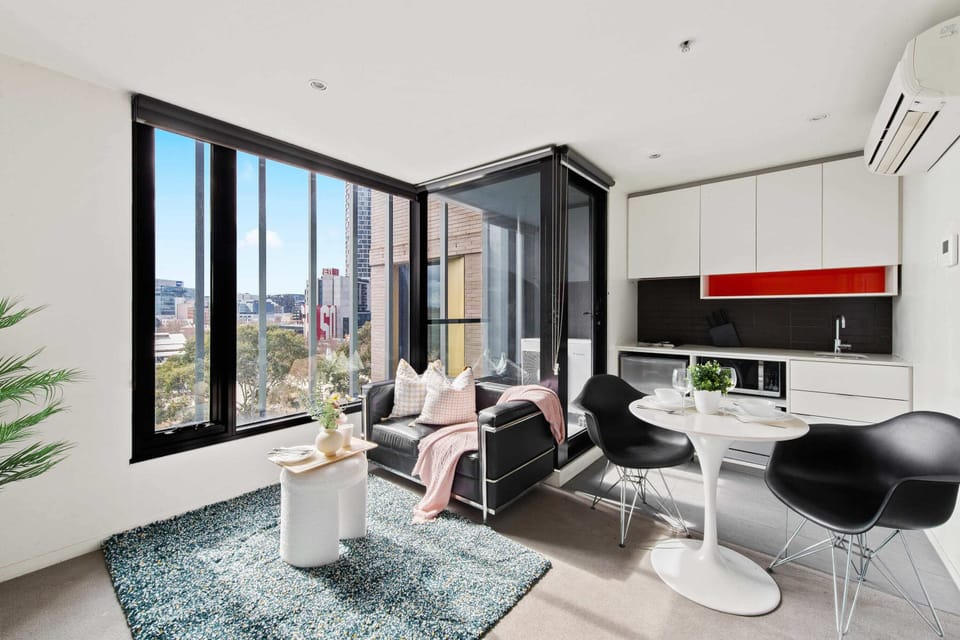 A cozy & well furnished interior with a kitchen & dining.