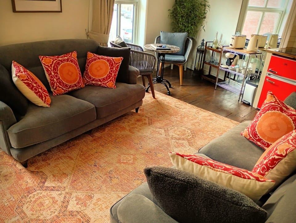 Large lounge with kitchenette, dining area, and 2 large sofas. 55" Smart TV.