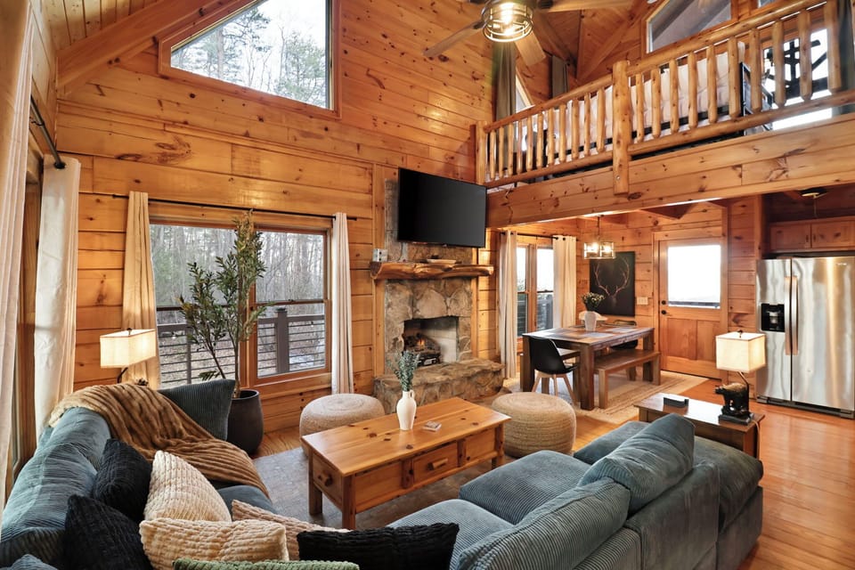 Gather in the inviting living room, featuring fireplace and comfortable seating.