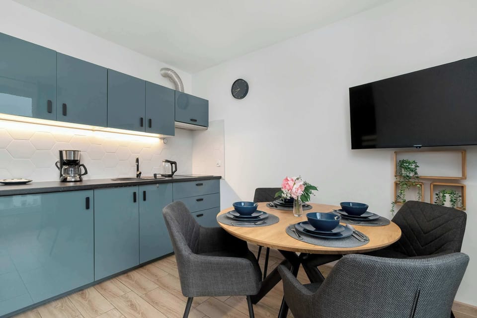 The thoughtfully arranged space with a large window connects the dining area with the living room, offering guests a bright and comfortable spot for shared meal