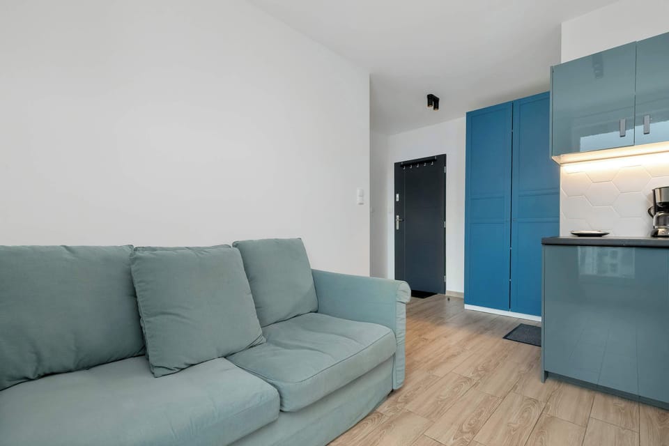 The comfortable sofa facing the open layout creates an ideal spot for relaxation, conversation, and slow afternoons.