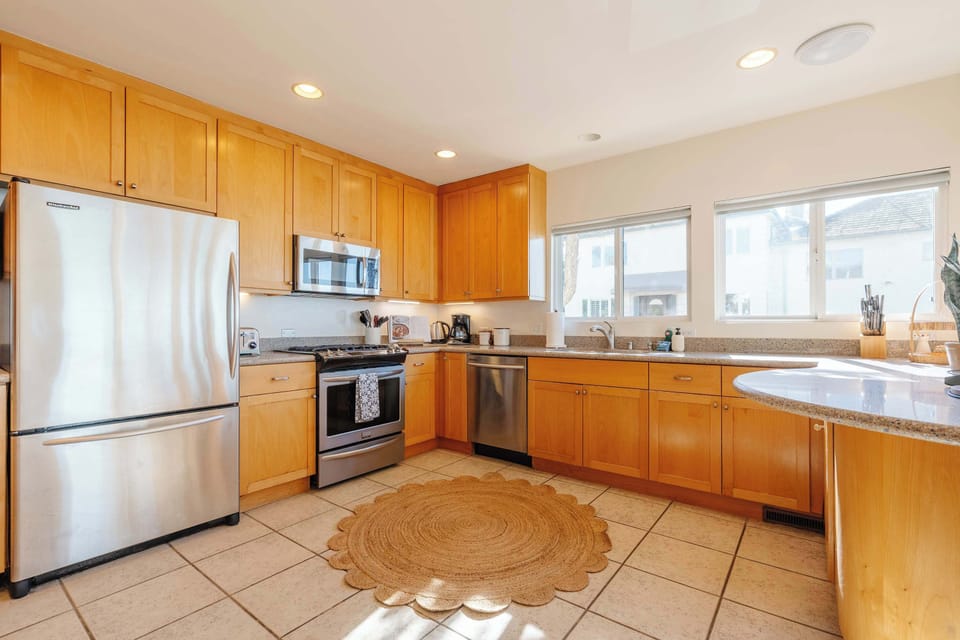 Savor meals prepared in the gourmet kitchen, featuring high-end appliances and a stylish dining area perfect for memorable gatherings.