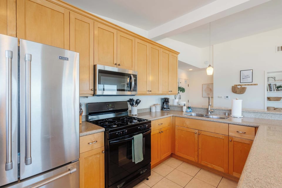 This bright kitchen offers beautiful views, enhancing the joy of family meals and culinary creativity.