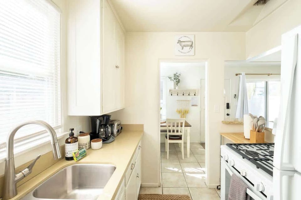 The charming, galley-style kitchen comes equipped with everything you need