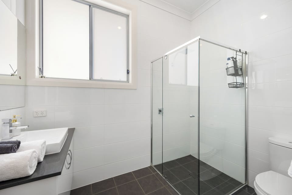 The ensuite’s walk-in shower, clean finishes and easy layout offer a straightforward, refreshing start to the day.