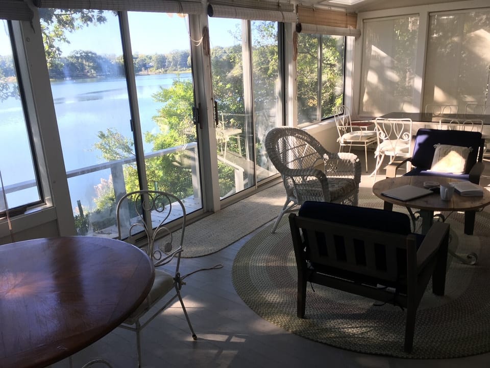 porch with views, dining tables, and seating area