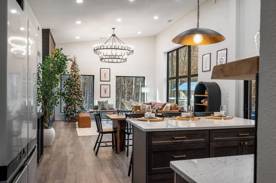 Open-concept great room with dining + living space and tall ceilings