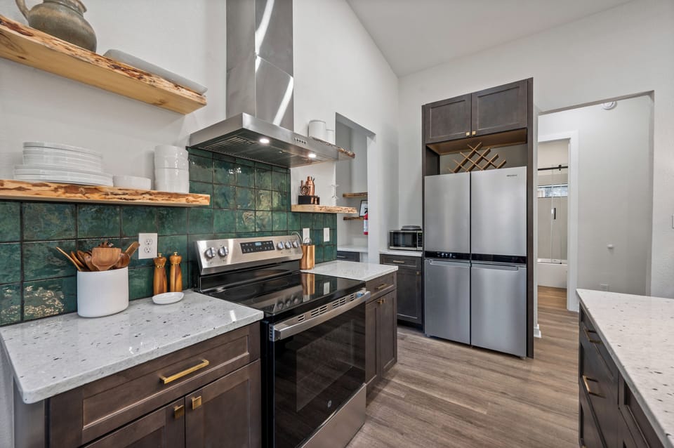 Fully stocked kitchen with stainless appliances and prep space