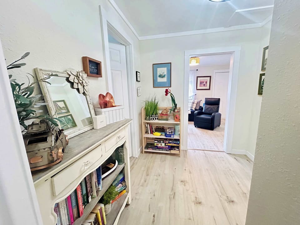 Step into this bright, welcoming hallway where thoughtful touches and cozy reading nooks create your home away from home.