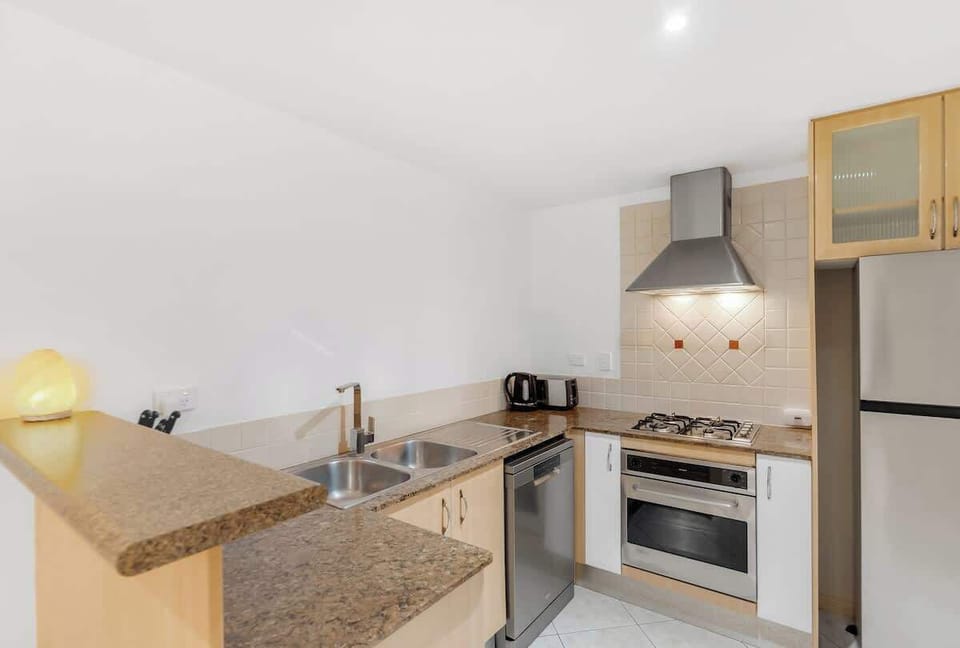 The kitchen creates an easy cooking experience with its gas cooktop, oven, dishwasher, Nespresso machine and thoughtful touches that support simple, home-style meals.