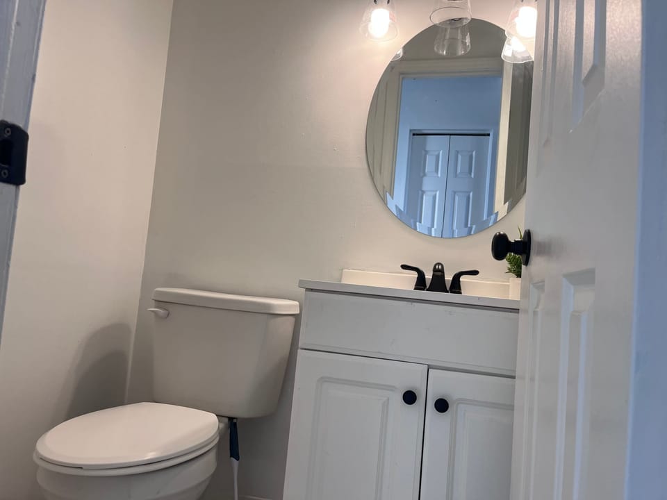 Half Bathroom: The vanity area is clean and has complimentary toiletries, so you can quickly freshen up before you head out.