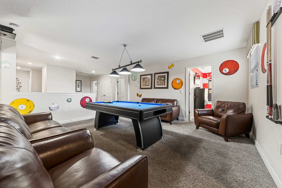 A fun, open loft featuring a pool table and games, perfect for friendly competition and family fun.