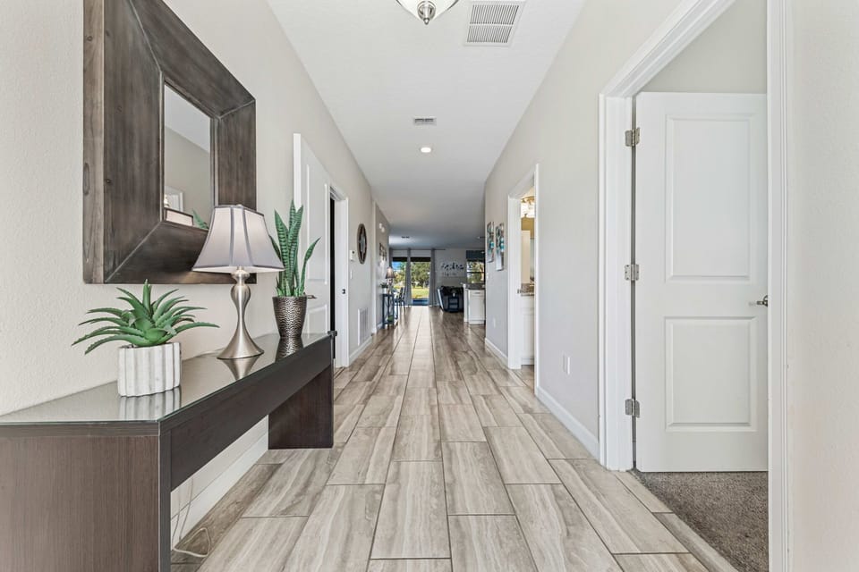 Step into a bright, welcoming foyer that sets the tone for your stay, with elegant décor and a spacious layout that leads into the home’s open living areas.