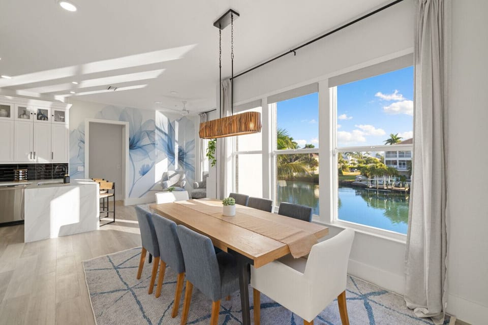 Modern dining area with wraparound water view windows