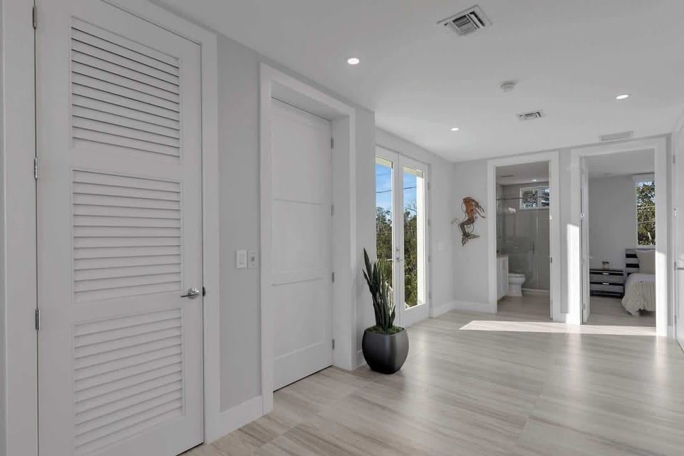 A discreet, modern elevator is conveniently located within the home, seamlessly integrated behind a door for easy access between floors.