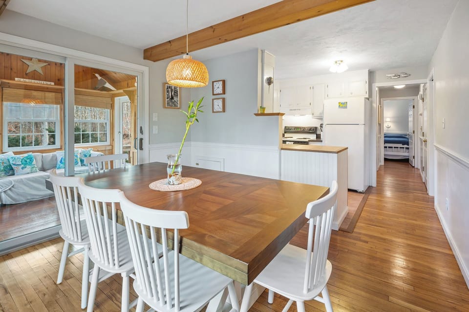 Dining area flows beautifully into both the kitchen and sunroom.