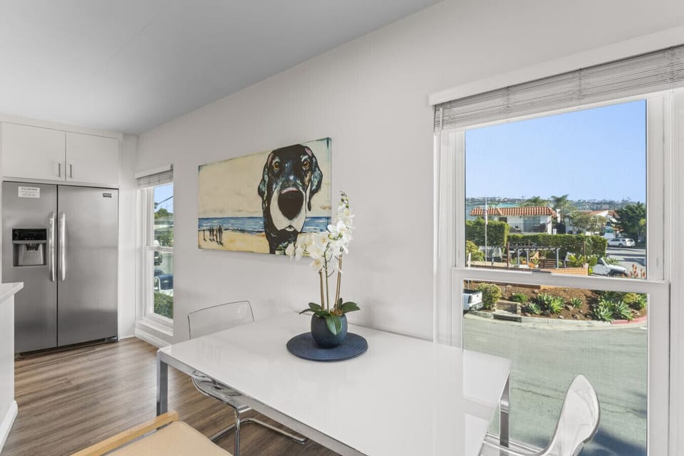 Sunny dining nook w/ large windows, perfect for enjoying meals in natural light