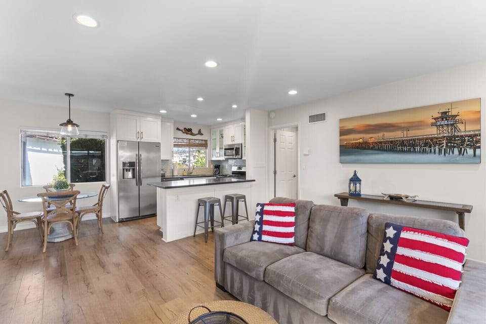 Open-concept living & kitchen area w/ comfortable seating and bright, airy feel