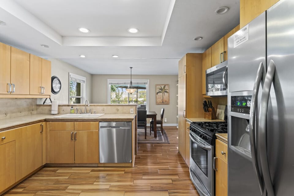 Functional kitchen w/ ample counter space, stainless appliances & a central dining nook