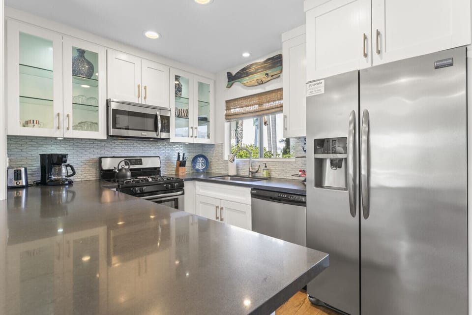 Bright kitchen w/ stainless appliances & ample counter space for cooking