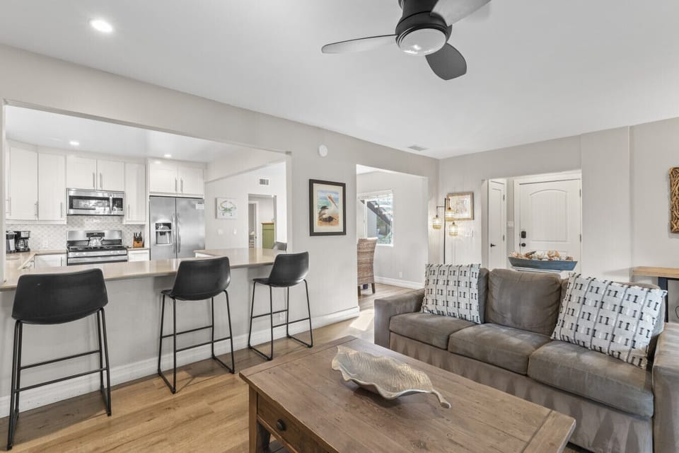 Open living & kitchen area w/ bar seating, perfect for gathering & casual meals