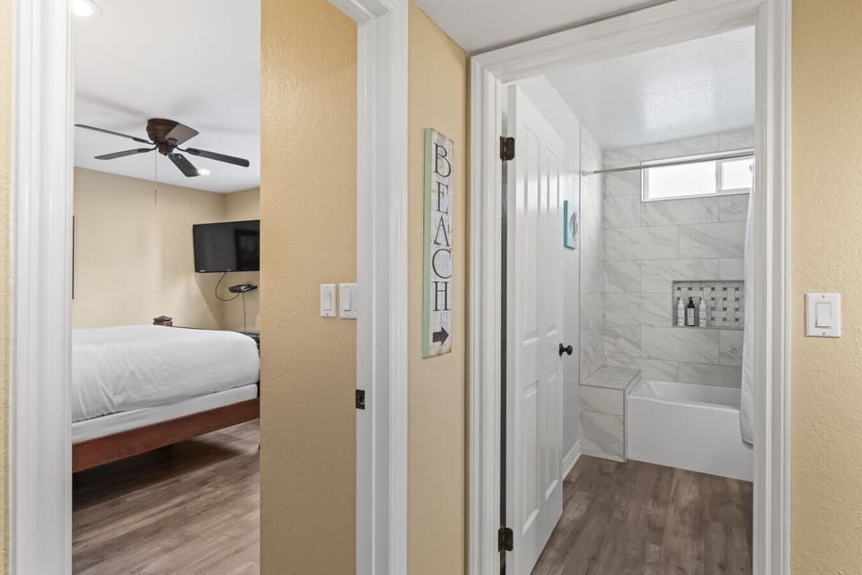 Hallway view connecting bedroom & bathroom for easy flow between spaces