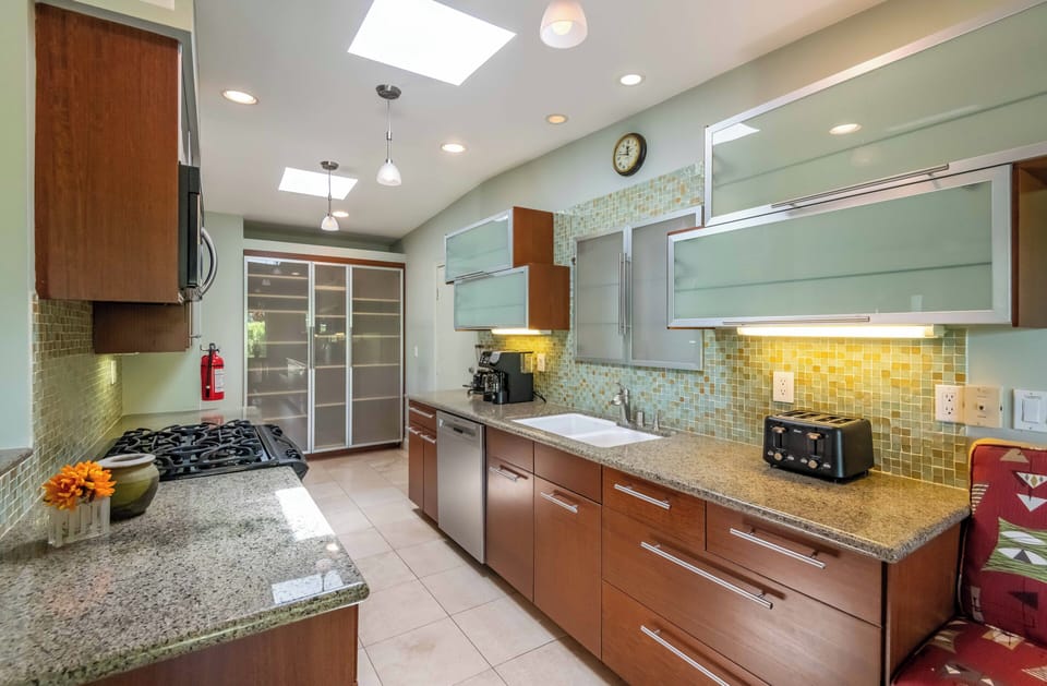 Chef's kitchen with granite counters, gas range & premium appliances
